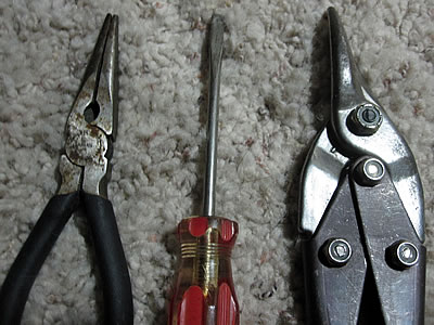 Needle nose pliers, screwdriver, and metal cutter